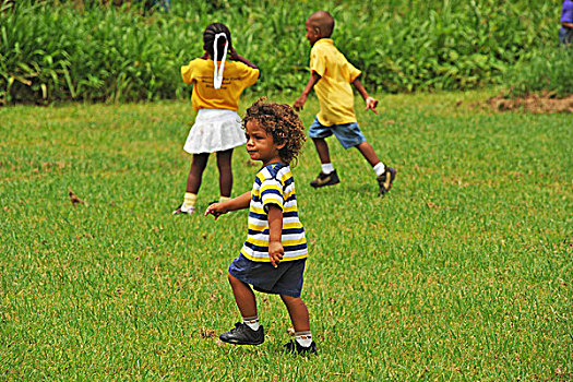 dominica,carib,territory,children,playing,soccer,at,a,school,fair,with,respect,yellow,t-shirt