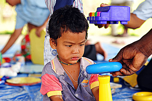 dominica,carib,territory,little,boy,playing,with,colorful,ludic,toys,unicef,animator