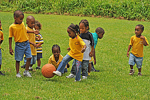 dominica,carib,territory,children,playing,soccer,at,a,school,fair,with,respect,yellow,t-shirt