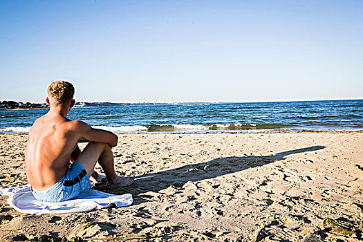 男青年,坐,海滩,向外看,海洋