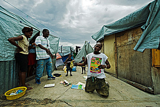 haiti,port,au,prince,man,showing,war,is,declared,magazine,in,camp,champ,de,mars