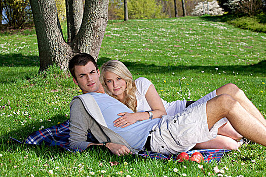 年轻,情侣,躺着,野餐毯,公园,春天