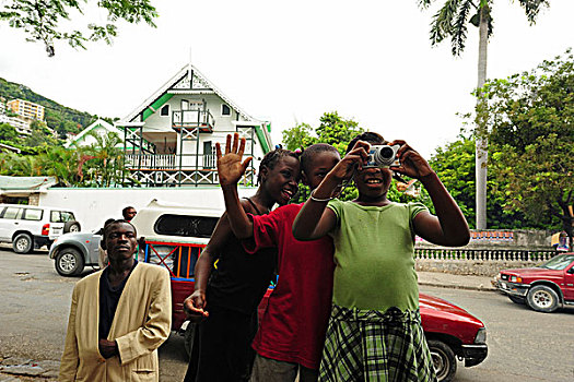 haiti,port,au,prince,children,learning,to,take,photographs,in,camp,st,pierre