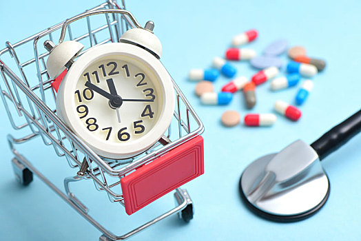 蓝色背景上的各种药品,听诊器和放在购物车里的时钟,靠药物购买换取生命时间