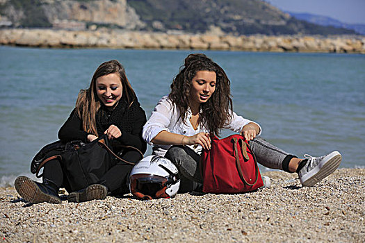 两个,女朋友,青少年,坐,海滩,包,头盔,曼顿,阿尔卑斯滨海省,普罗旺斯,法国,欧洲