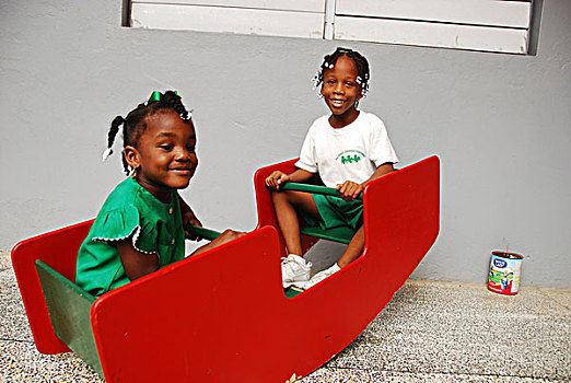 dominica,roseau,preschool,social,center,young,schoolgirls,playing,on,swing