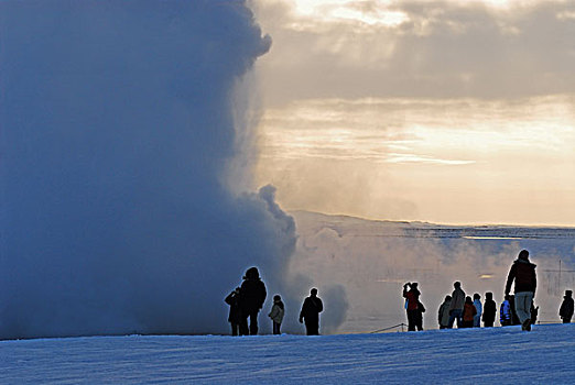 iceland,geysir,tourist,people,looking,at,steam,coming,out,from,the,geyser,in,snow,environment