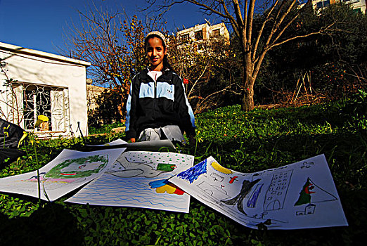 algeria,alger,midsection,of,a,schoolgirl,showing,her,drawings