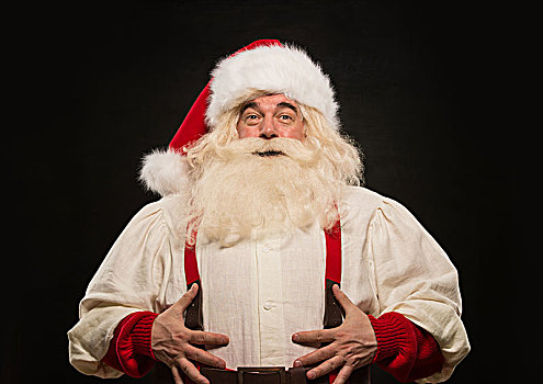 圣诞老人,笑,拿着,腹部,深色背景