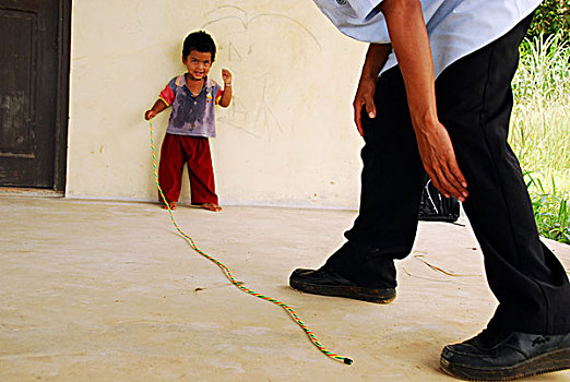 dominica,carib,territory,little,boy,with,colorful,necklace,playing,rope