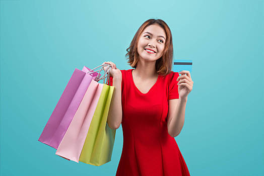 女人,拿着,购物,购物袋,信用卡,站立,蓝色背景