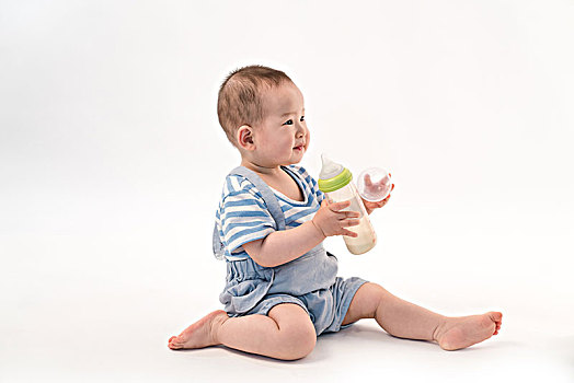 可爱宝宝坐在地上喝牛奶