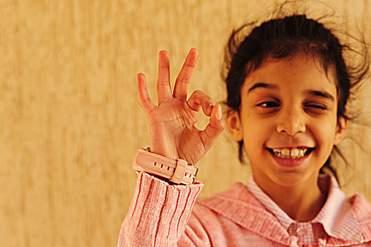 kuwait,city,portrait,of,kuweiti,girl,winking,and,making,the,perfect,sign