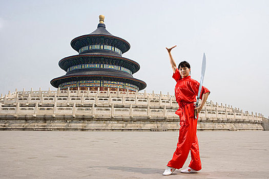 中国武术--一名女武术运动员在天坛祈年殿前练刀法