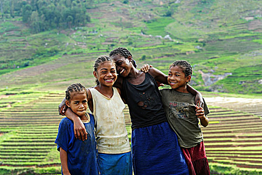 madagascar,ambalavao,young,girls,laughing,in,front,of,terraced,ricefields