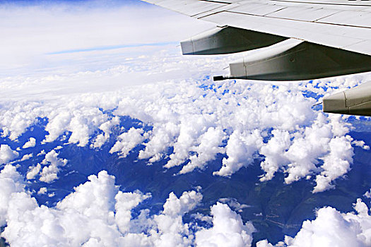 飞机机翼白色云层绿色山川