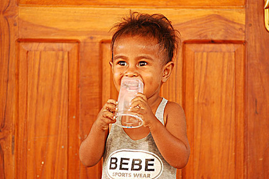 timorese,girl,with,bad,teeth,smiling,friend,plastic,glass,of,water