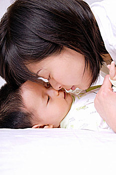 妈妈和熟睡的男婴碰鼻头