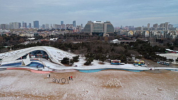 龙年瑞雪悄然而至,游客漫游海边赏雪打卡