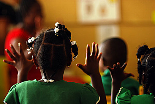 dominica,roseau,preschool,social,center,rear,portrait,of,girl,with,braids