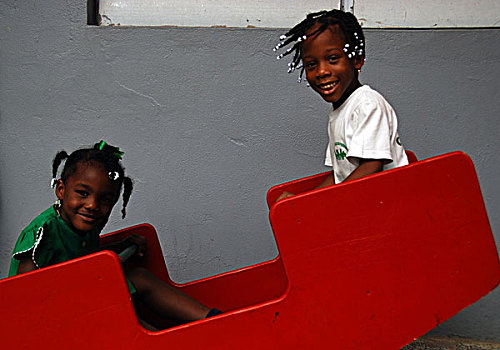 dominica,roseau,preschool,social,center,young,schoolgirls,playing,on,swing