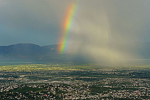 haiti,port,au,prince,view,of,a,rainbow,storm,from,montagne,noire