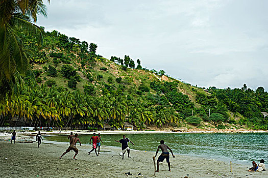 haiti,jacmel,young,adults,playing,soccer,on,the,beach