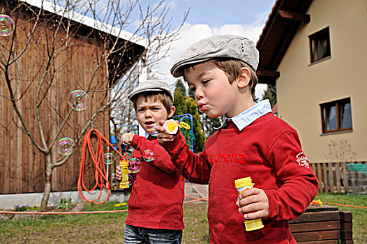 双胞胎,男孩,戴着,平顶帽,吹,肥皂泡,花园