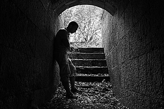 年轻,悲伤,男人,站立,暗色,石头,隧道,发光,黑白图片