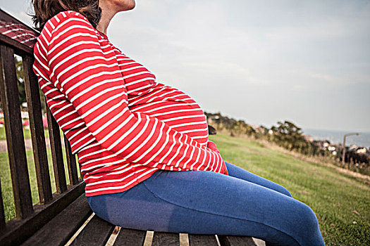 孕妇,坐,长椅,草,边缘,穿,红色,条纹,上面,牛仔裤