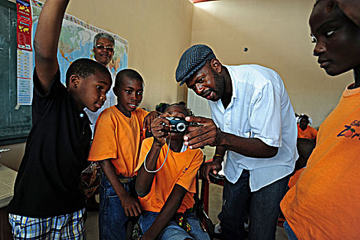 haiti,port,au,prince,teacher,helping,handicapped,boy,taking,photograph