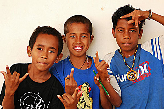 east-timor,timor-leste,dili,asian,girl,with,red,tshirt,pointing,at,the,camera