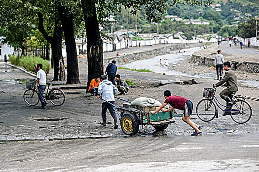 朝鲜平壤街头用小推车小拉车运输货物的人