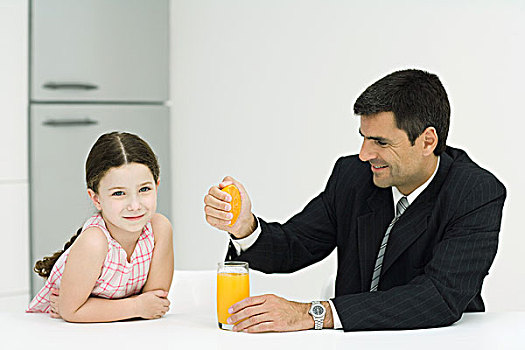 父亲,女儿,坐,一起,桌子,男人,挤,橙汁,玻璃,女孩,看镜头,微笑