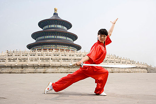 中国武术--一名女武术运动员在天坛祈年殿前练刀法