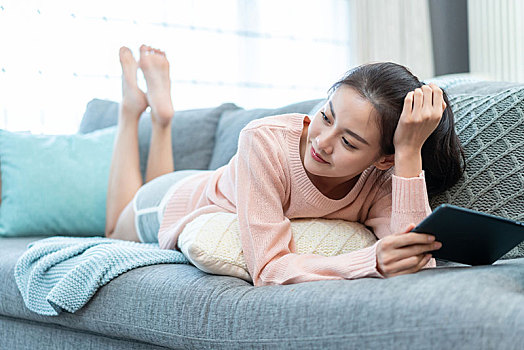 年轻女子在家使用平板电脑