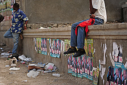 haiti,port,au,prince,man,calling,on,top,of,advertisement,presidential,candidate,leslie,voltaire