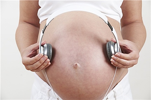 特写,孕妇,拿着,耳机,上方,腹部