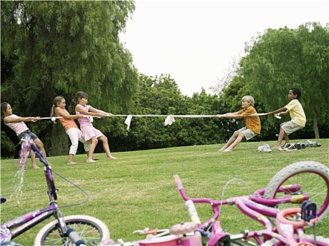 一群孩子,7-9岁,玩,拔河,草地,公园,侧面,自行车,前景