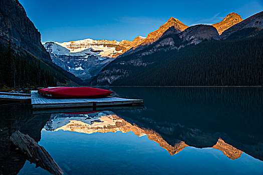 独木舟在码头,在黎明,路易丝湖,班芙国家公园,阿尔伯塔,加拿大