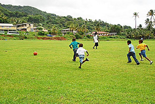 dominica,carib,territory,children,playing,soccer,at,a,school,fair,with,respect,yellow,t-shirt