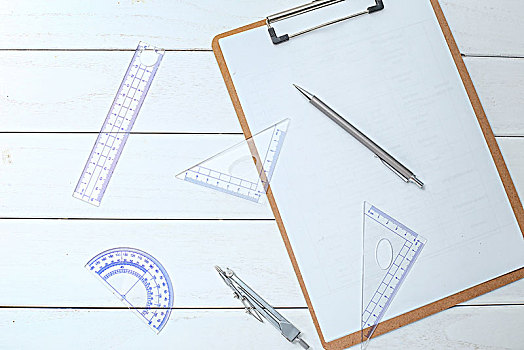 白色木桌上的三角板,圆规,直尺,量角器