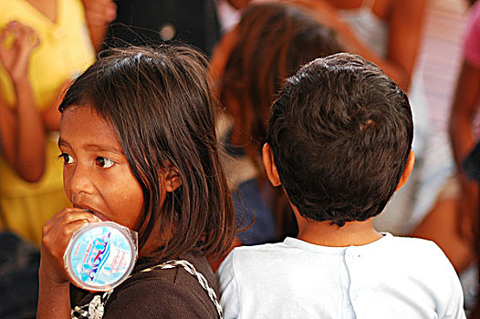 portrait,of,timorese,boy,with,plastic,glass,in,his,mouth