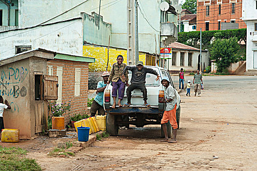 madagascar,fianarantsoa,children,having,fun,on,parked,car