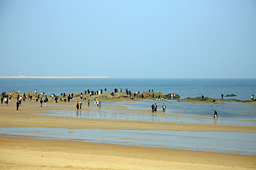 阳春三月暖意浓,游客漫步海滩放飞心情