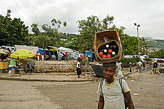 haiti,port,au,prince,boy,selling,drinks,in,camp,place,st,pierre