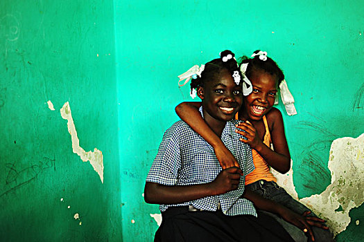 haiti,port,au,prince,portrait,of,2,girls,friends,hugging