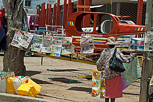 madagascar,fianarantsoa,newspaper,hanging,between,trees,next,to,helicopter,fair,game,for,children