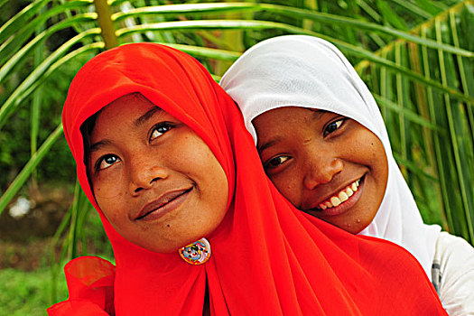 indonesia,sumatra,banda,aceh,two,smiling,girl,looking,up,with,colorful,veil