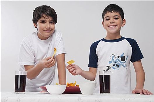肖像,两个男孩,吃,烤干酪辣味玉米片